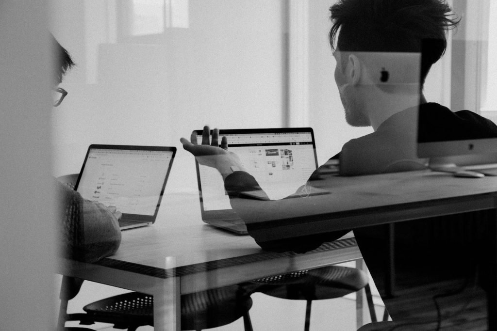 Team reviewing plans on sticky notes and a laptop